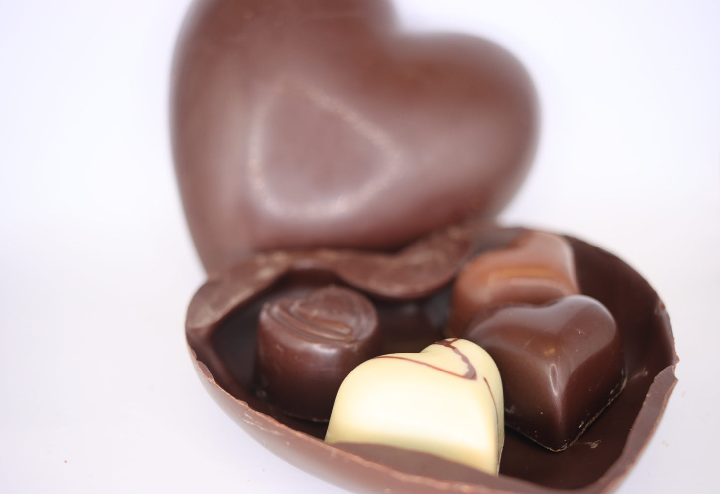 Handcrafted hollow chocolate heart filled with 4 confections