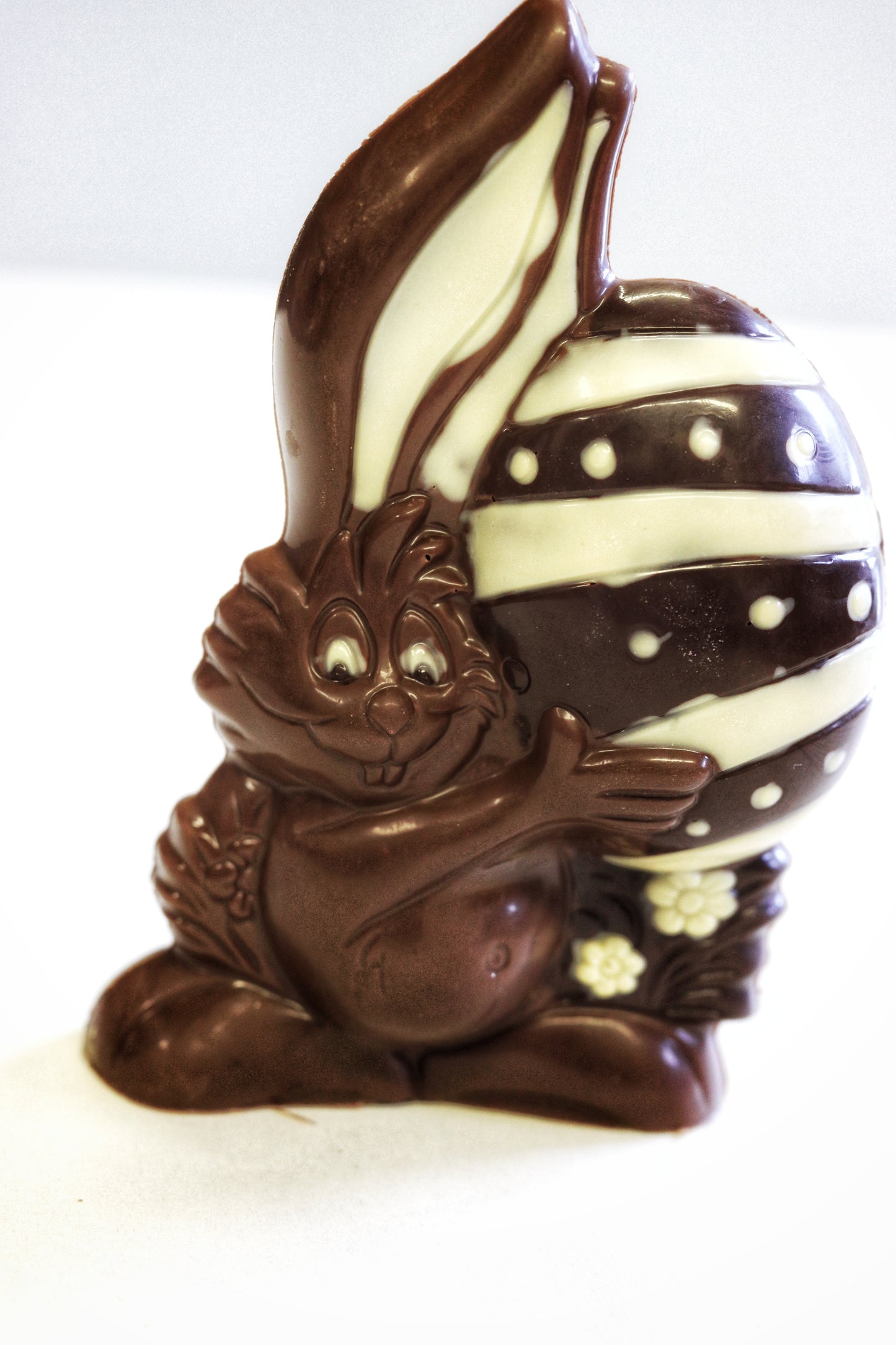 handmade chocolate easter bunny holding egg with flowers by Nelson's Chocofellar